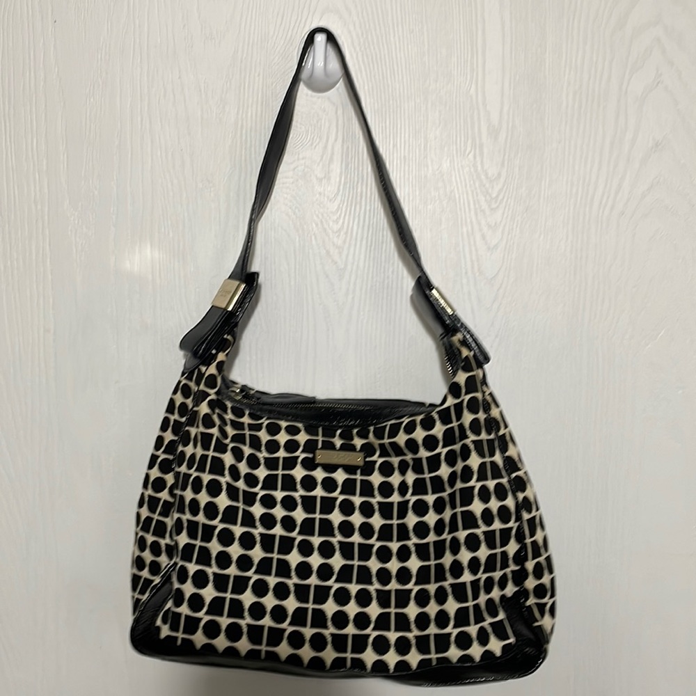 Kate spade cloth and leather purse with circular design and gold hardware